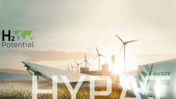 Auf dem Bild ist in hellen Farben zu sehen: Container mit der Aufschrift EnergyStorage, Solarpanele und Windräder.