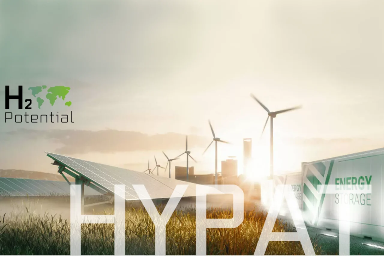 Auf dem Bild ist in hellen Farben zu sehen: Container mit der Aufschrift EnergyStorage, Solarpanele und Windräder.